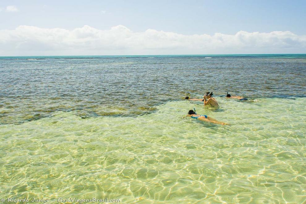 Imagem de turistas aproveitando a piscina natural de Moreré na Ilha de Boipeba